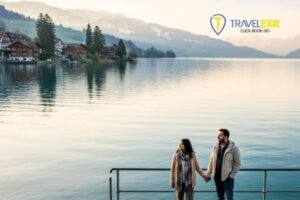 Couple on a lakeside promenade in Switzerland during their affordable Switzerland honeymoon in Zurich with Alpine mountains in the background