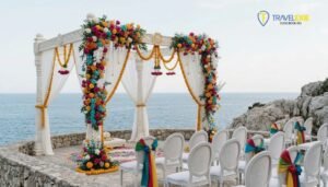 Beachside destination wedding setup abroad for Indian couples with floral mandap and ocean view